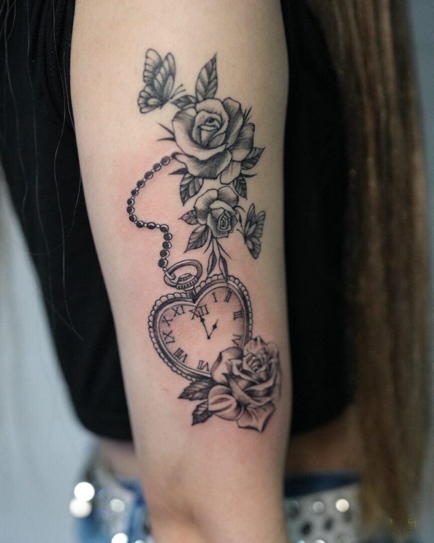 腕にハートの懐中時計と薔薇と蝶のタトゥー(Heart-Shaped Pocket Watch, Rose, and Butterfly Tattoo on the Arm)